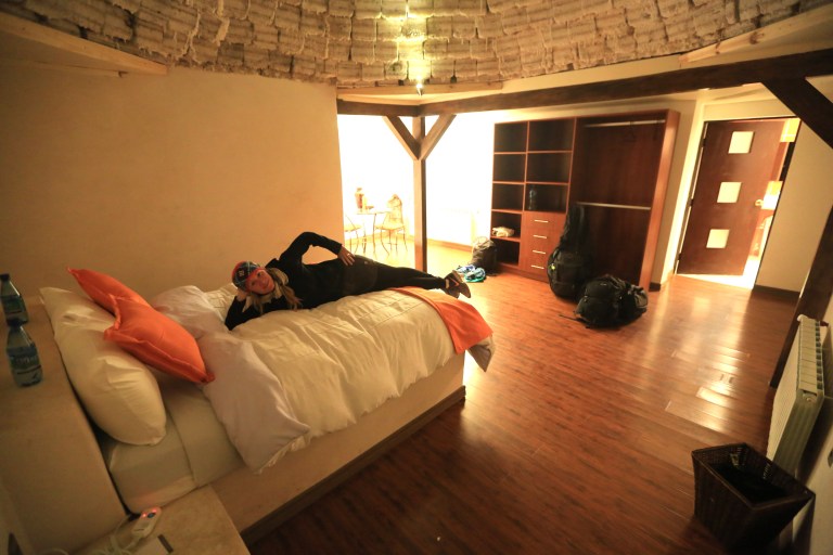 Katie lounging in the comfy bed in the salt hotel