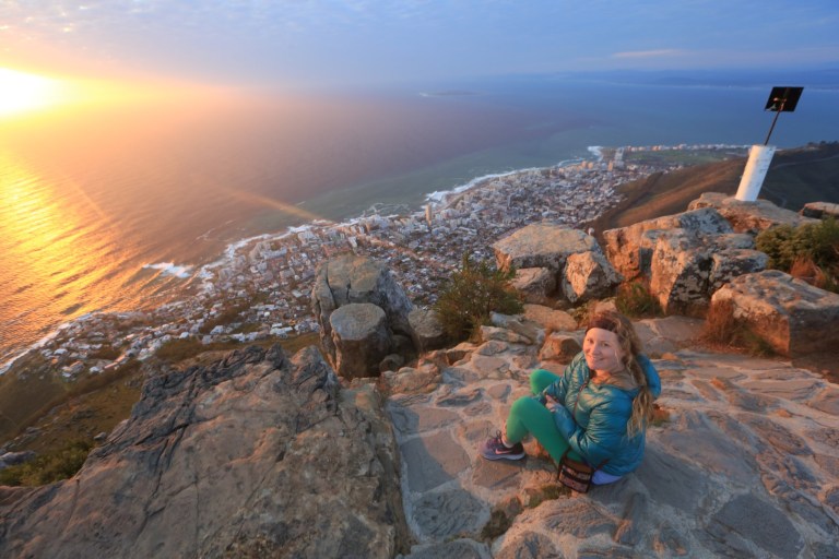 Katie sits on the Lion's Head mountain overlooking Cape Town