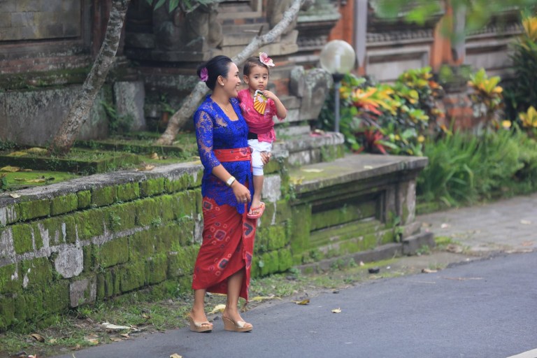 Carrying a child, dressed for the holiday