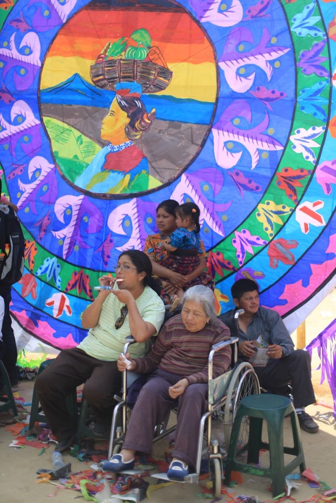Families sit in front of the kites to display their pride